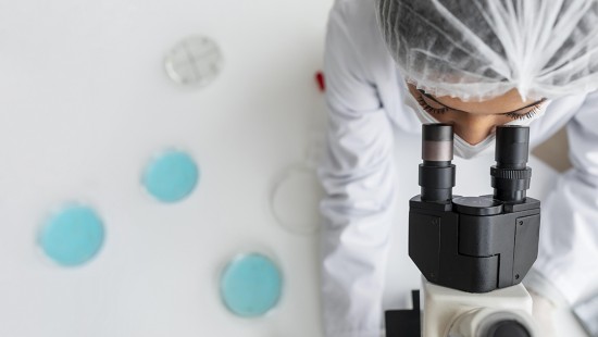 close-up-researcher-looking-through-ocular-lens